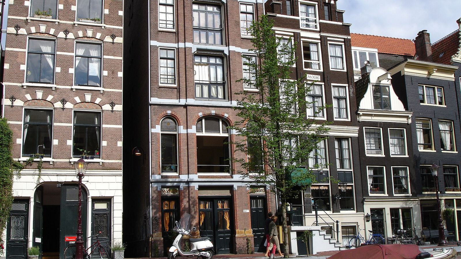 Canal houses and a boat on an Amsterdam canal